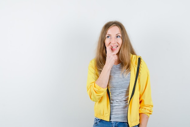 Young blonde woman in a yellow jacket