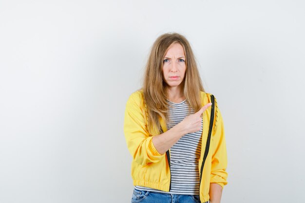 Young blonde woman in a yellow jacket