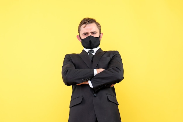 Young boss listening carefully to his employees in a protective mask