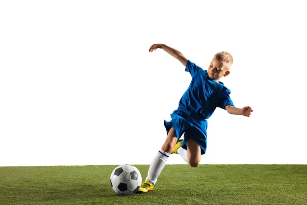 Foto gratuita ragazzo giovane come un giocatore di calcio o di football in abbigliamento sportivo che fa una finta o un calcio con la palla per un gol su sfondo bianco.