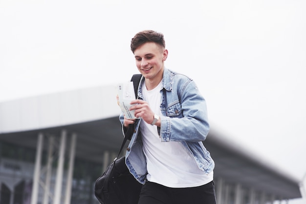 Young boy in a blue denim jacket on the street.