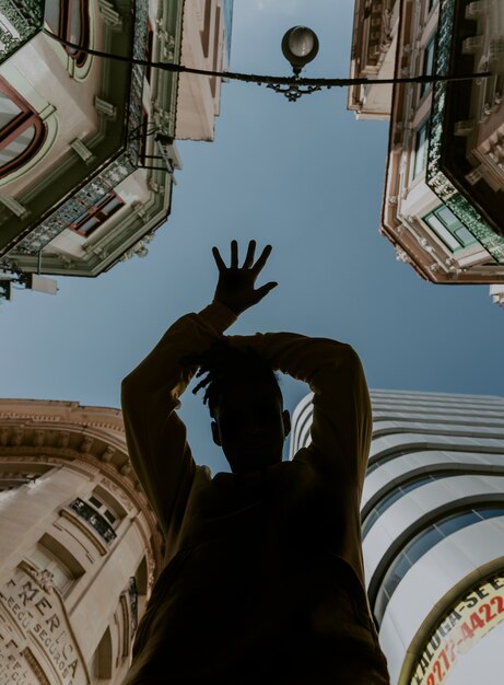 Young boy dancing around in the city