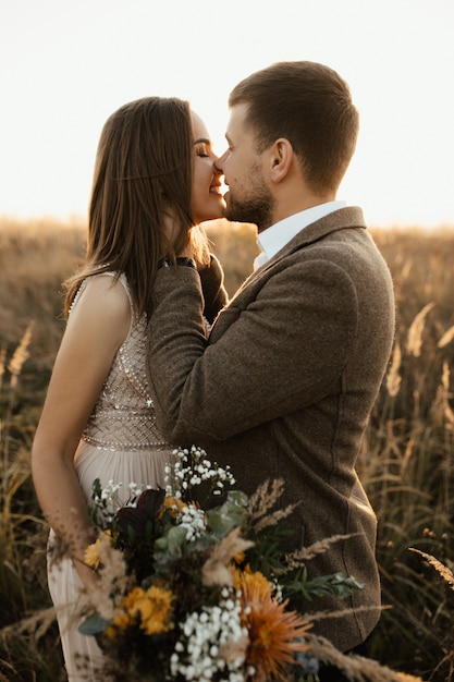 Young boy and girl gently kiss in nature