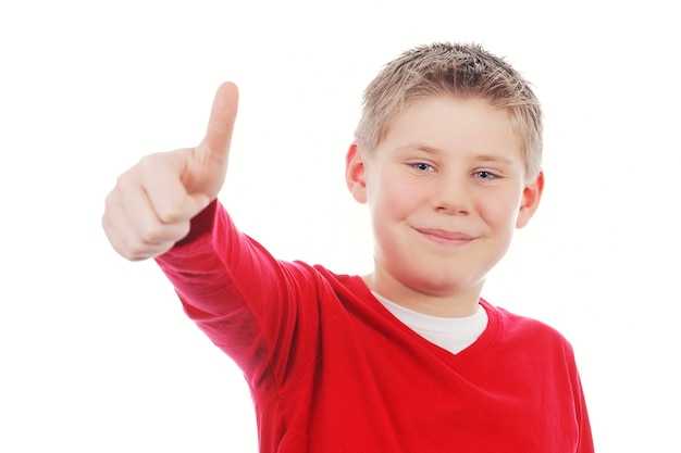 Young boy giving you thumb up isolated on white space