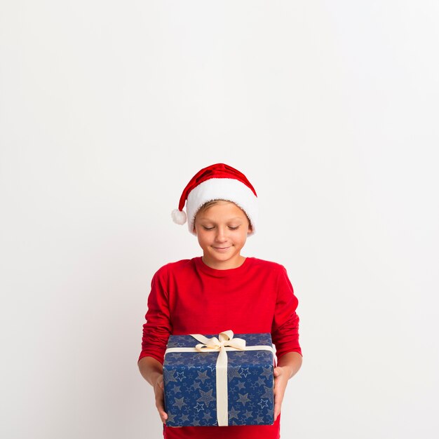 Young boy holding gift copy space