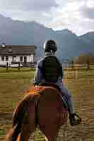 Free photo young boy learning how to ride horse