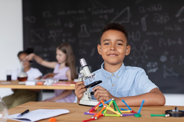 Young boy learning more about chemistry in class