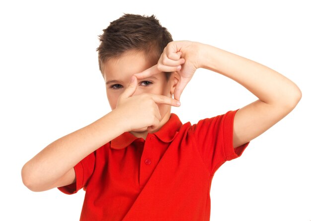 Young boy looking through frame shape made by hands isolated on white