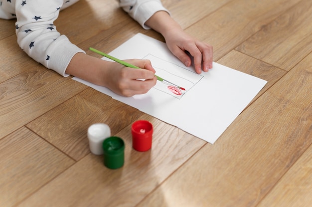 Young boy painting the bulgarian flag at home