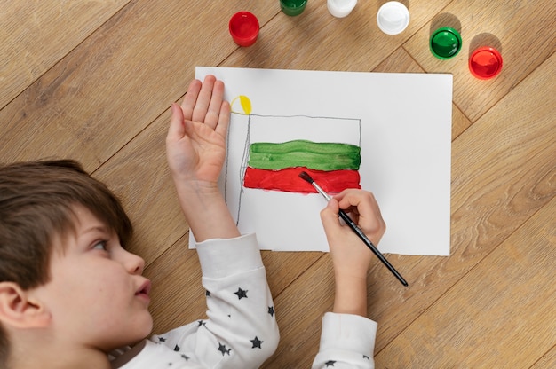 Free photo young boy painting the bulgarian flag at home