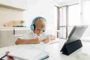 Free photo young boy paying attention to online class