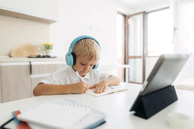 Young boy paying attention to online class