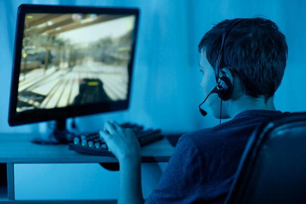 Young boy playing on computer