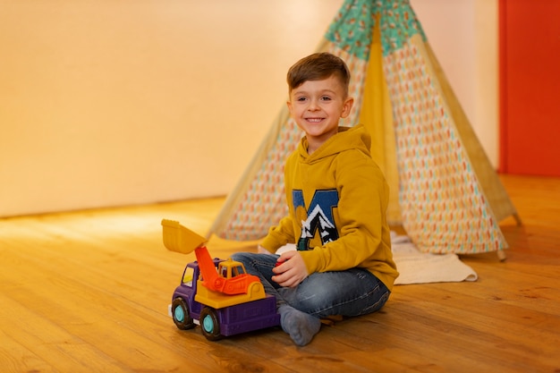 Young boy playing indoors with eco toys