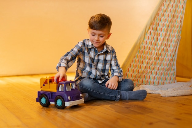 Young boy playing indoors with eco toys