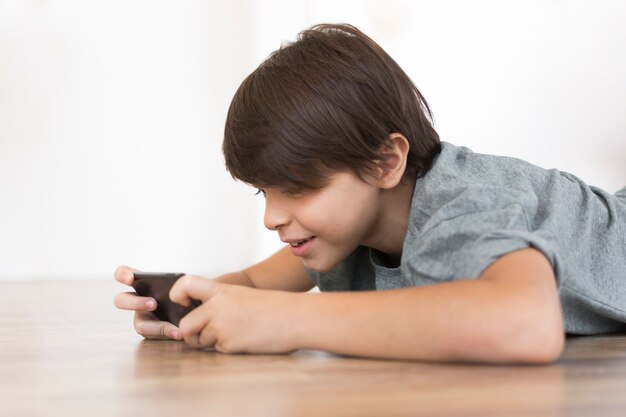 Young boy playing on smartphone