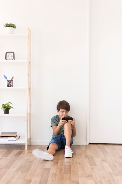 Young boy playing on smartphone