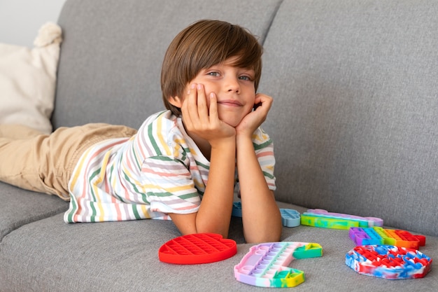 Young boy playing with fidget toy at home