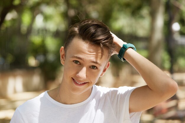 Young boy wearing white T-shirt in park