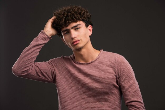 Young boy with curly hairstyle thinking. 