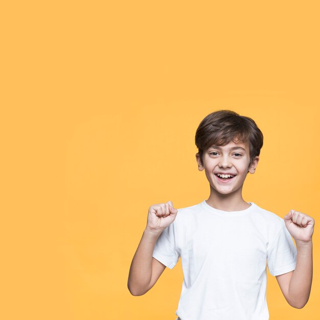 Young boy with fists closed