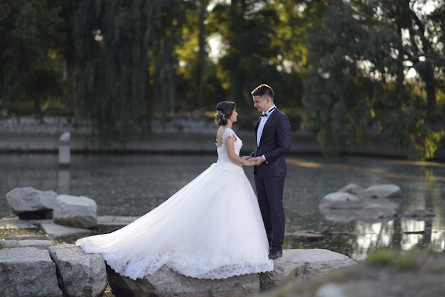 Free photo young bride and groom in wedding dress