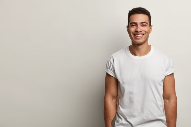 Young brunet man wearing white T-shirt