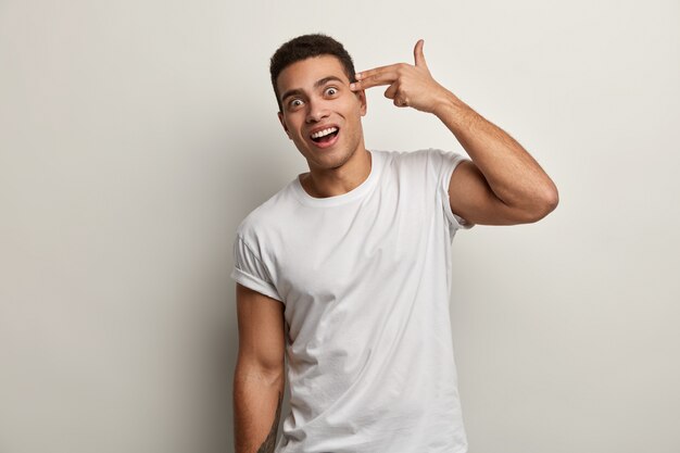 Young brunet man wearing white T-shirt