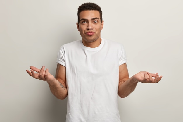 Young brunet man wearing white T-shirt