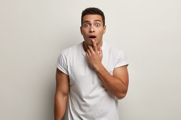 Young brunet man wearing white T-shirt