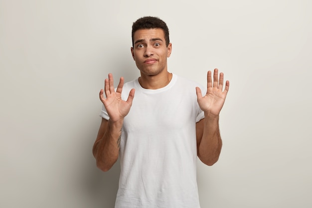 Young brunet man wearing white T-shirt