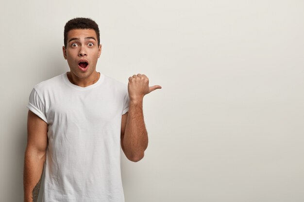 Young brunet man wearing white T-shirt