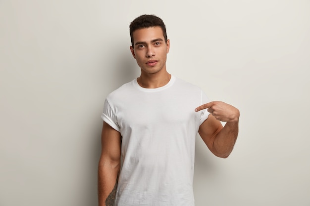 Free photo young brunet man wearing white t-shirt