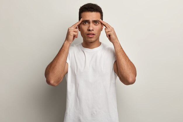 Young brunet man wearing white T-shirt