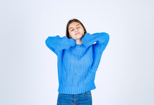 Young brunette girl feeling sleepy on white.