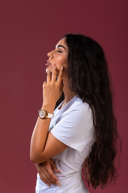 Young brunette girl posing in model casting, profile view in thinking positiion.