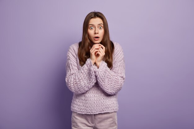 Young brunette woman in cozy winter clothes