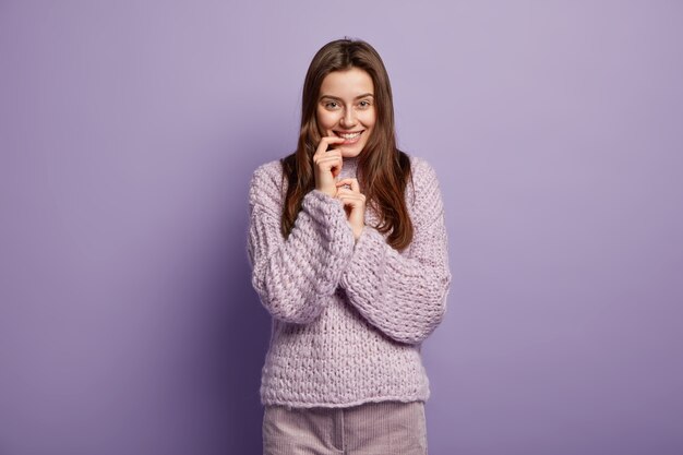 Young brunette woman in cozy winter clothes