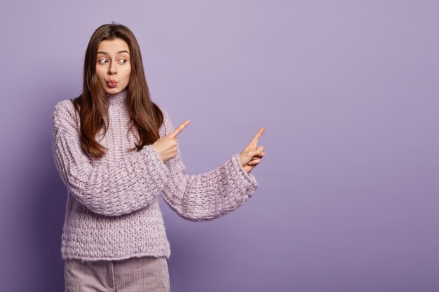 Young brunette woman in cozy winter clothes