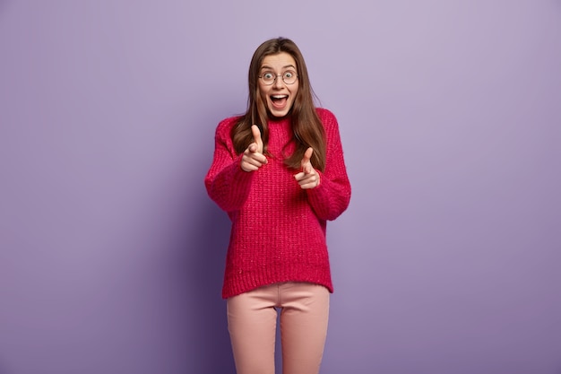 Young brunette woman in cozy winter clothes