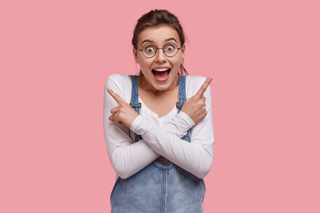 Young brunette woman in denim overalls