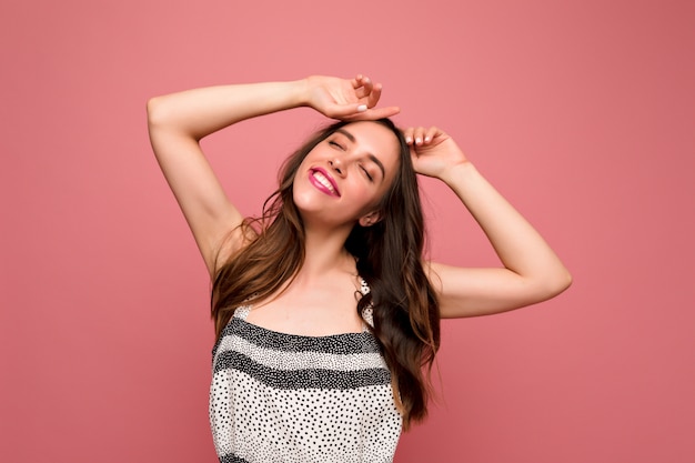 Young brunette woman in grey dress posing