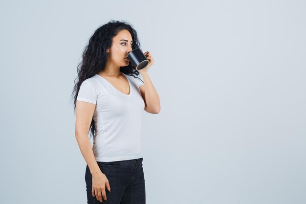 Young brunette woman holding a mug