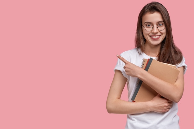 Young brunette woman holding notepads