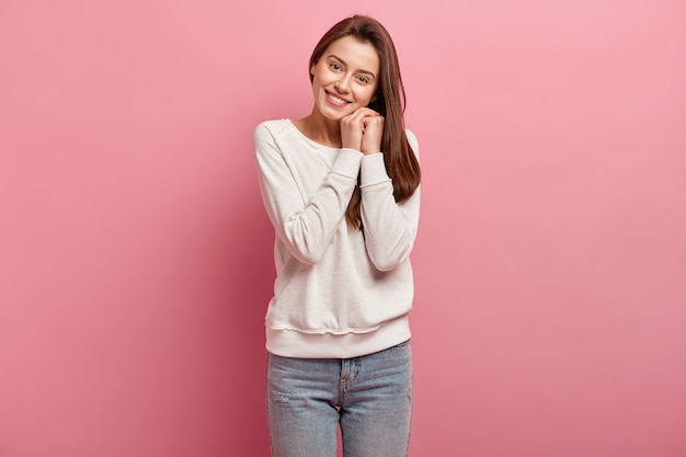 Young brunette woman in jeans and sweater