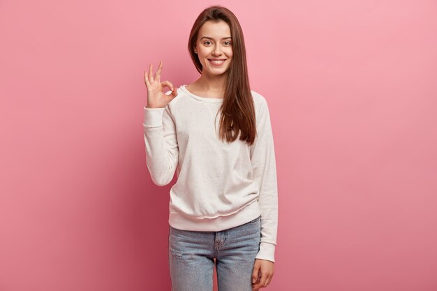 Young brunette woman in jeans and sweater