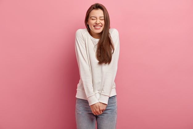 Young brunette woman in jeans and sweater