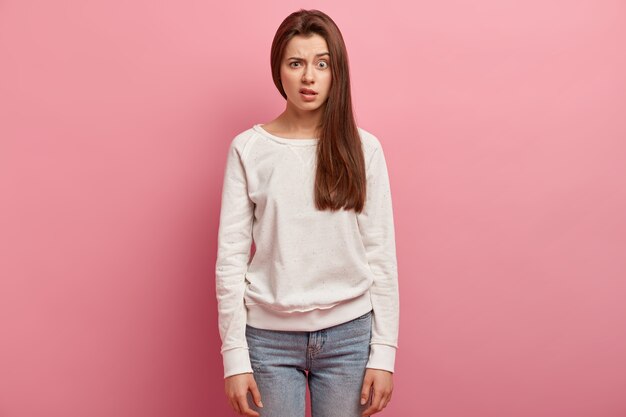 Young brunette woman in jeans and sweater