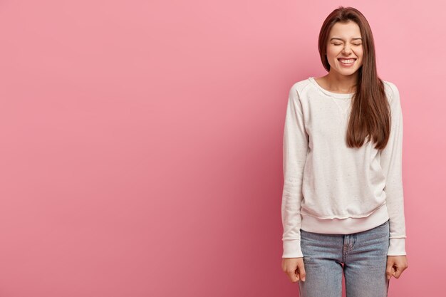 Young brunette woman in jeans and sweater