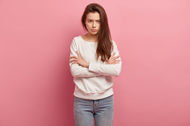 Young brunette woman in jeans and sweater